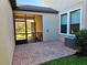 View of the screened patio with brick pavers, exterior wall, and an A/C unit at 3367 Janna Grace Way, Land O Lakes, FL 34638