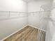 Walk-in closet with installed shelving, hardwood flooring, and ample storage space at 3367 Janna Grace Way, Land O Lakes, FL 34638