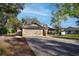 Charming single-story home with a stone facade, a brick driveway, and mature landscaping at 3416 S 70Th St, Tampa, FL 33619