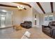 Open-concept living room with tile floors, beamed ceilings, and a view into the kitchen at 3416 S 70Th St, Tampa, FL 33619