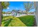 Well maintained lawn in the backyard with a view of the back of the house at 3709 W Dale Ave, Tampa, FL 33609