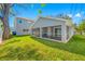 A screened-in porch overlooks the spacious, well-maintained lawn at 3709 W Dale Ave, Tampa, FL 33609