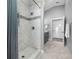 Elegant bathroom features a tiled shower, a white vanity, and marble tiled floors at 3709 W Dale Ave, Tampa, FL 33609