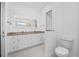 Bright bathroom with double vanity, granite countertop, and ample lighting at 3709 W Dale Ave, Tampa, FL 33609