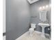 A sleek bathroom with a pedestal sink and modern fixtures creates a clean and inviting space at 3709 W Dale Ave, Tampa, FL 33609