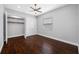 Spacious bedroom with wood floors, closet, ceiling fan, and a window at 3709 W Dale Ave, Tampa, FL 33609
