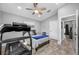 Neutral bedroom featuring a comfortable bed, a ceiling fan, and space for exercise equipment at 3709 W Dale Ave, Tampa, FL 33609