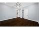 This bedroom features a ceiling fan, gray walls and hardwood floors at 3709 W Dale Ave, Tampa, FL 33609