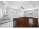 Bonus room with grey countertop, stainless steel sink, dark wood floors, and two ceiling fans at 3709 W Dale Ave, Tampa, FL 33609