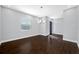 Dining room with hardwood floors, bright window, and modern chandelier, adjacent to the home's entryway at 3709 W Dale Ave, Tampa, FL 33609
