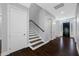 Inviting entryway with dark wood floors, staircase, and a stylish front door with decorative glass accents at 3709 W Dale Ave, Tampa, FL 33609