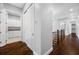 Hallway with dark wood floors and views of the staircase, bathroom, and bonus room at 3709 W Dale Ave, Tampa, FL 33609