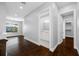 Bright hallway featuring dark wood floors, grey walls and a view of the bathroom and walk-in closet at 3709 W Dale Ave, Tampa, FL 33609