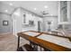 Well-lit kitchen with white cabinets, stainless appliances, bar seating, and open access to other rooms at 3709 W Dale Ave, Tampa, FL 33609