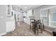 Bright kitchen features white cabinetry, stainless appliances, bar seating, and a window with natural light at 3709 W Dale Ave, Tampa, FL 33609