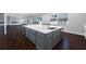 A large kitchen island with a white countertop provides space for meal preparation and casual dining at 3709 W Dale Ave, Tampa, FL 33609