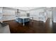 Spacious kitchen with white cabinets, marble backsplash, stainless steel appliances, and large island at 3709 W Dale Ave, Tampa, FL 33609