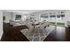 Open-concept living and dining area with modern furnishings and a fireplace at 3709 W Dale Ave, Tampa, FL 33609