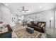 Inviting living room with a leather sofa, open to the kitchen, with ample natural light and neutral tones at 3709 W Dale Ave, Tampa, FL 33609