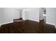 Open-concept living room with dark hardwood floors and neutral walls at 3709 W Dale Ave, Tampa, FL 33609