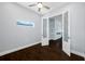 Office with dark wood floors, a modern accent wall, and french doors at 3709 W Dale Ave, Tampa, FL 33609