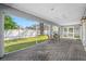 Inviting screened patio with brick flooring, offering seamless indoor-outdoor living at 3709 W Dale Ave, Tampa, FL 33609