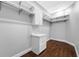 Walk-in closet with dark wood floors, white shelves and a custom cabinet at 3709 W Dale Ave, Tampa, FL 33609