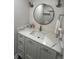 This bathroom features a modern vanity with a marble countertop and a stylish round mirror at 4237 Brentwood Park Cir, Tampa, FL 33624