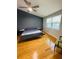Bright bedroom with wood floors, a ceiling fan, a large window, and a comfy bed at 4237 Brentwood Park Cir, Tampa, FL 33624