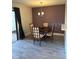 Dining room with modern lighting fixture, table, and dark-colored accent wall at 4237 Brentwood Park Cir, Tampa, FL 33624