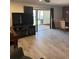This living room offers a ceiling fan, hardwood floors, and sliding glass doors to the patio and dining room at 4237 Brentwood Park Cir, Tampa, FL 33624