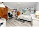 Cozy bedroom with wood-look floors, fan, and abundant natural light from the arched window at 4614 Sandpointe Dr, New Port Richey, FL 34655