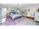 Bright bedroom with a large window, stylish furnishings, and hardwood-style floors at 4614 Sandpointe Dr, New Port Richey, FL 34655