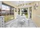 Bright breakfast nook with white table and chairs, and large windows offering backyard views at 4614 Sandpointe Dr, New Port Richey, FL 34655