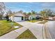 Suburban home with a two car garage, covered entryway and mature landscaping, including palm trees at 4614 Sandpointe Dr, New Port Richey, FL 34655