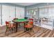 Community center game room with octagonal game table, chairs and built-in shelves stocked with games at 4614 Sandpointe Dr, New Port Richey, FL 34655