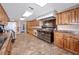 Community kitchen featuring modern appliances, wood cabinetry, and ample counter space at 4614 Sandpointe Dr, New Port Richey, FL 34655
