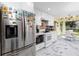 Well-equipped kitchen featuring stainless steel refrigerator and modern appliances with an adjacent eat-in kitchen at 4614 Sandpointe Dr, New Port Richey, FL 34655