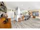 Bright kitchen with an eat-in island, counter seating, white cabinets, and modern appliances at 4614 Sandpointe Dr, New Port Richey, FL 34655