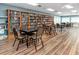 Community library with floor-to-ceiling bookshelves, tables, and chairs for quiet reading and study at 4614 Sandpointe Dr, New Port Richey, FL 34655