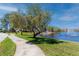 Beautiful view of the pond with a walking path and fountain, perfect for relaxing outdoors at 4614 Sandpointe Dr, New Port Richey, FL 34655