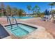 Resort-style pool with spa, blue umbrellas, and comfortable seating at 4614 Sandpointe Dr, New Port Richey, FL 34655