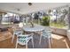Cozy screened porch featuring a ceiling fan and comfortable seating overlooking the backyard at 4614 Sandpointe Dr, New Port Richey, FL 34655