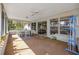 Spacious screened porch featuring ceiling fan, ample sunlight, and a view of the backyard at 4614 Sandpointe Dr, New Port Richey, FL 34655