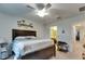 A cozy bedroom features a ceiling fan and easy access to an attached bathroom at 5312 Sylvester Loop, Tampa, FL 33610