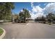 Gated community entrance with brick pillars and lush landscaping for a secure and welcoming entry at 5312 Sylvester Loop, Tampa, FL 33610