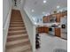 The kitchen features stainless appliances and wooden cabinetry, conveniently located near the staircase at 5312 Sylvester Loop, Tampa, FL 33610