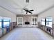 Spacious living room awaiting remodel featuring built-in shelves, fireplace, and large windows at 590 Baywood N Dr, Dunedin, FL 34698