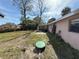 Exterior view of the house's backyard and the septic tank lid in the grass at 6042 Countryman Ln, New Port Richey, FL 34652