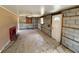 View of a room with a fireplace, windows, and cement block walls awaiting renovation at 6042 Countryman Ln, New Port Richey, FL 34652